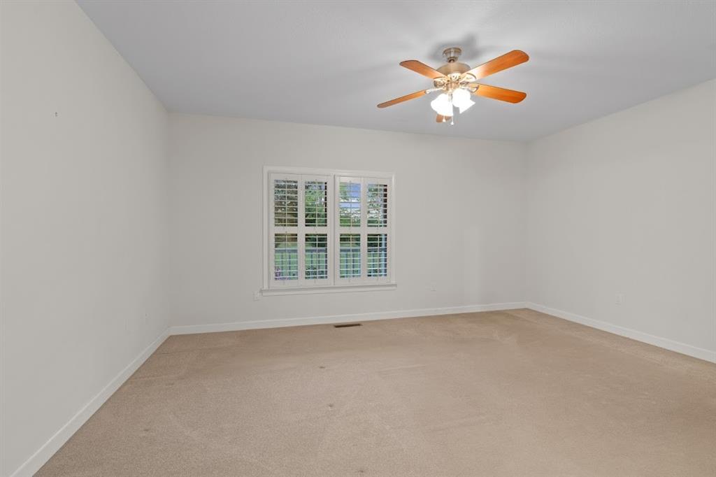 2239 Cross Roads Church Road Buchanan, GA 30113 - Photo 35 of 53 an empty room with ceiling fan and window