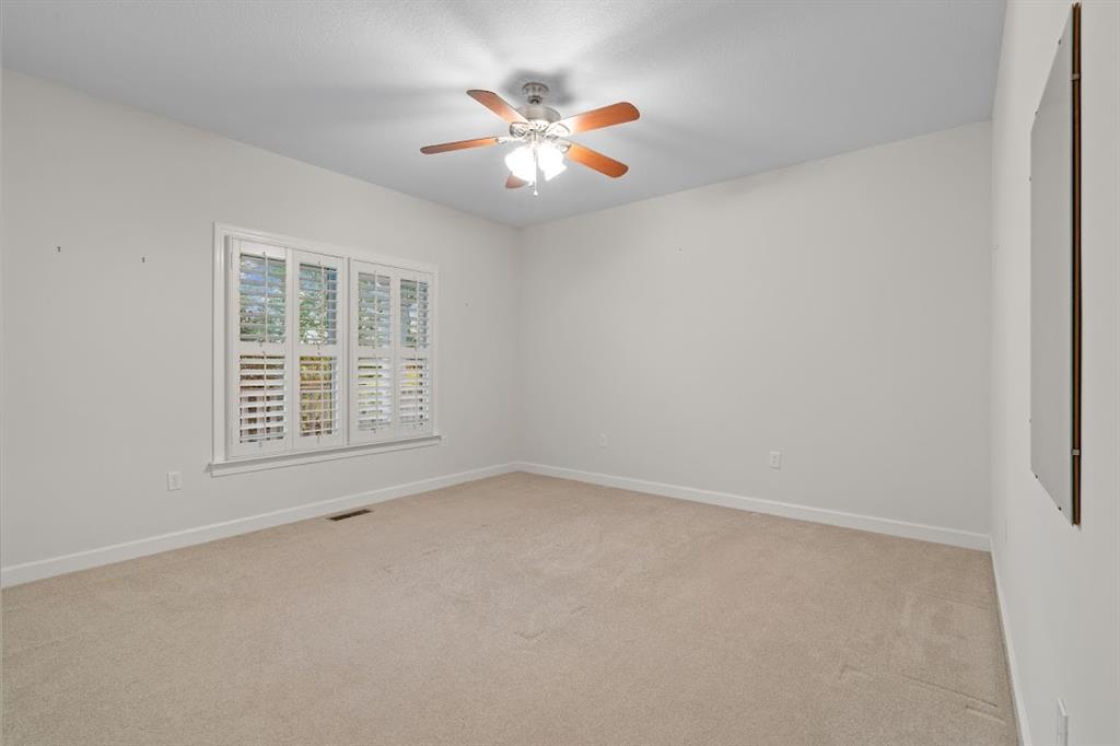 2239 Cross Roads Church Road Buchanan, GA 30113 - Photo 37 of 53 an empty room with window and ceiling fan