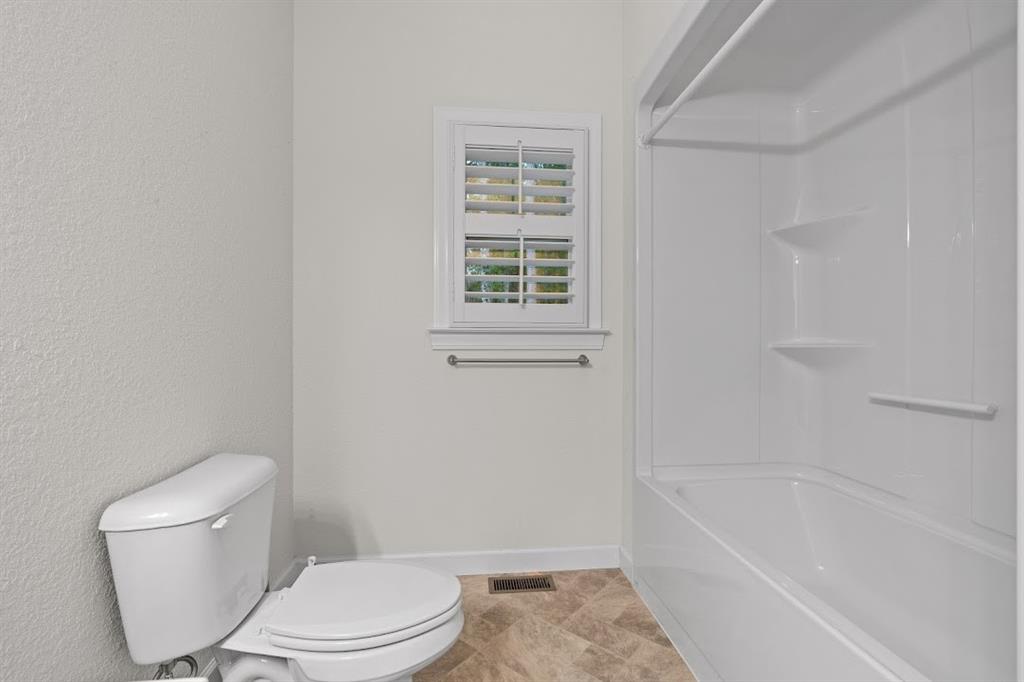 2239 Cross Roads Church Road Buchanan, GA 30113 - Photo 40 of 53 a white toilet and tub sitting next to a window