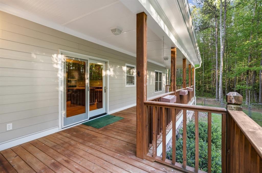 2239 Cross Roads Church Road Buchanan, GA 30113 - Photo 53 of 53 a view of a balcony with a floor to ceiling window and wooden floor