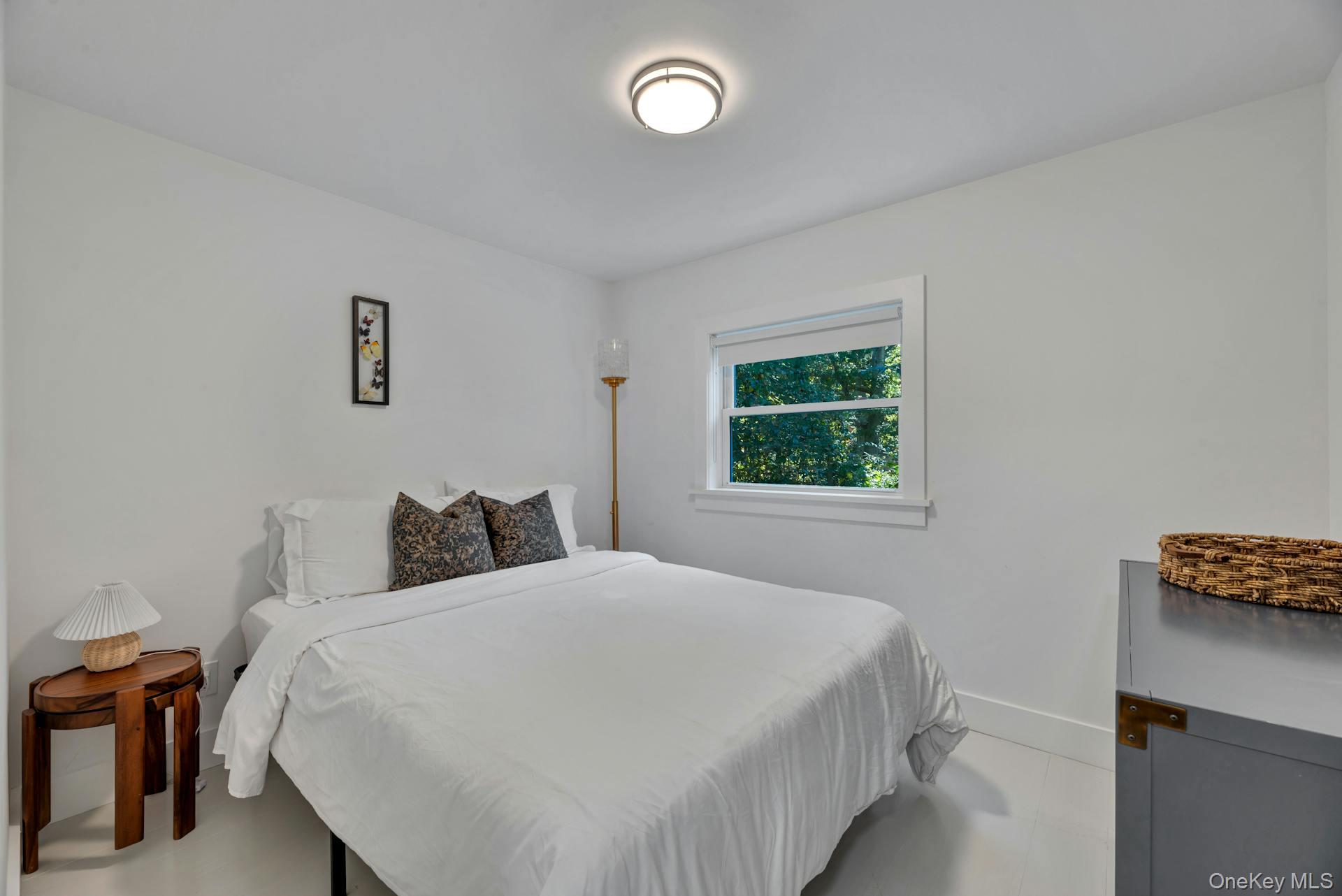 3670 Rocky Point Road East Marion, NY 11939 - Photo 12 of 27 a bedroom with a bed and a window