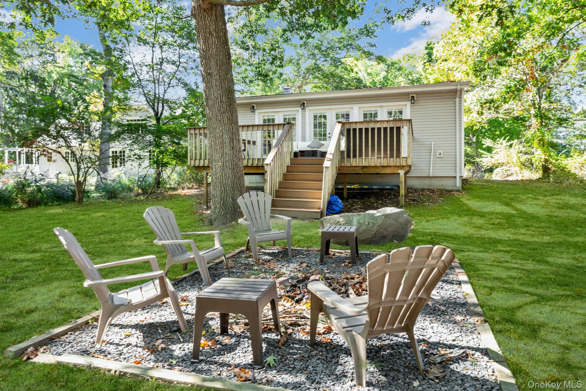 3670 Rocky Point Road East Marion, NY 11939 - Photo 20 of 27 a view of a chair and table in backyard of the house