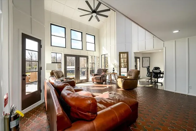 a kitchen with refrigerator a stove a sink dishwasher with a dining table and chairs