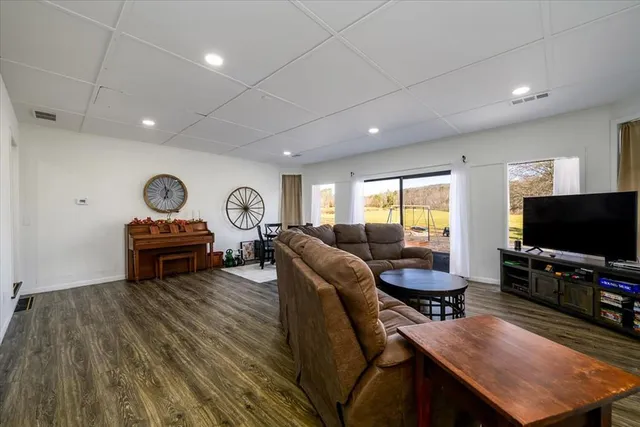 a living room with furniture dining table and wooden floor