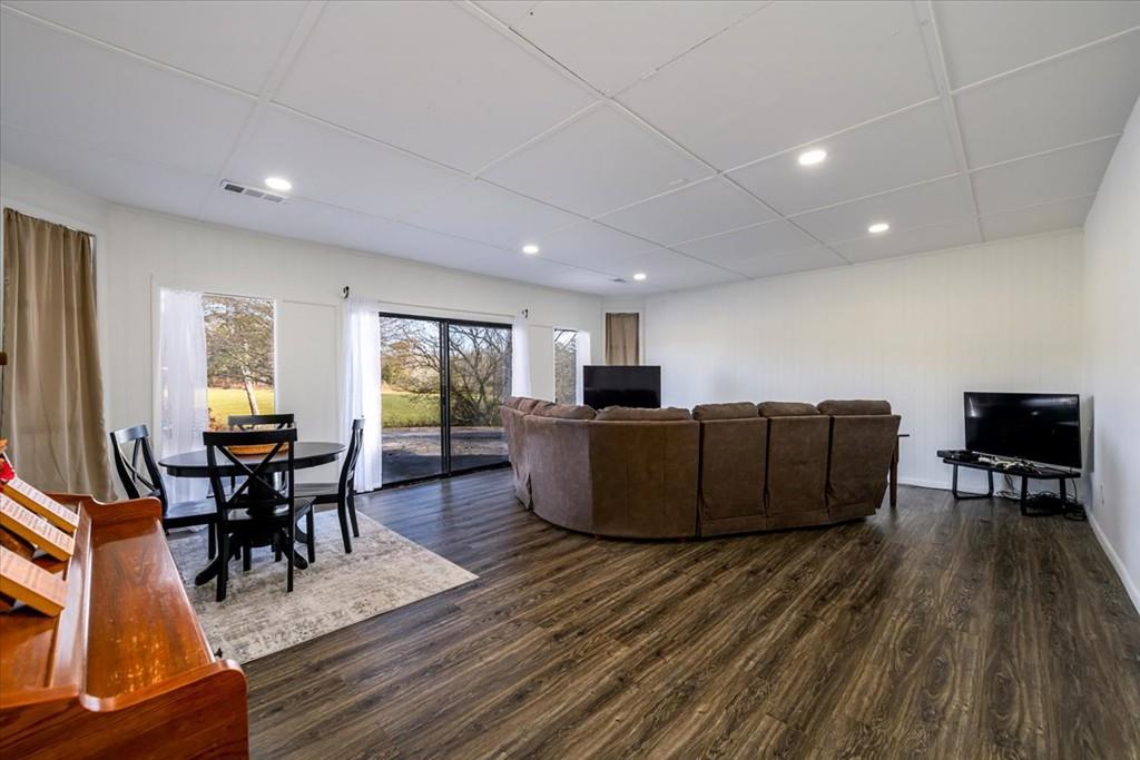 3274 Highway 255 Sautee Nacoochee, GA 30571 - Photo 15 of 77 a living room with furniture a large window wooden floor and a flat screen tv
