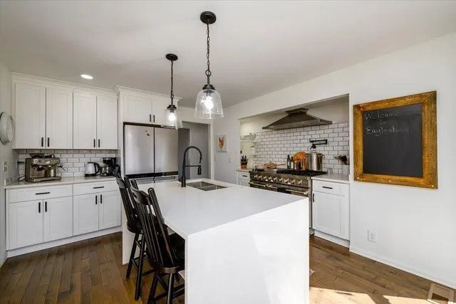 a view of entryway with wooden floor and a front door