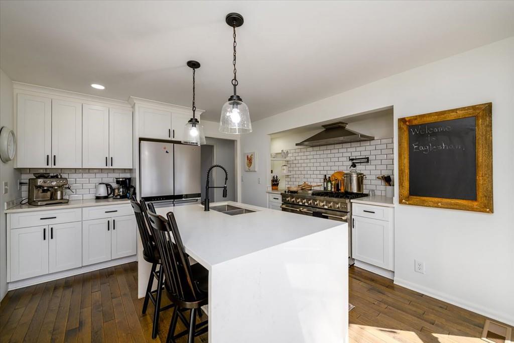 3274 Highway 255 Sautee Nacoochee, GA 30571 - Photo 18 of 77 a kitchen with refrigerator a stove a sink dishwasher with a dining table and chairs