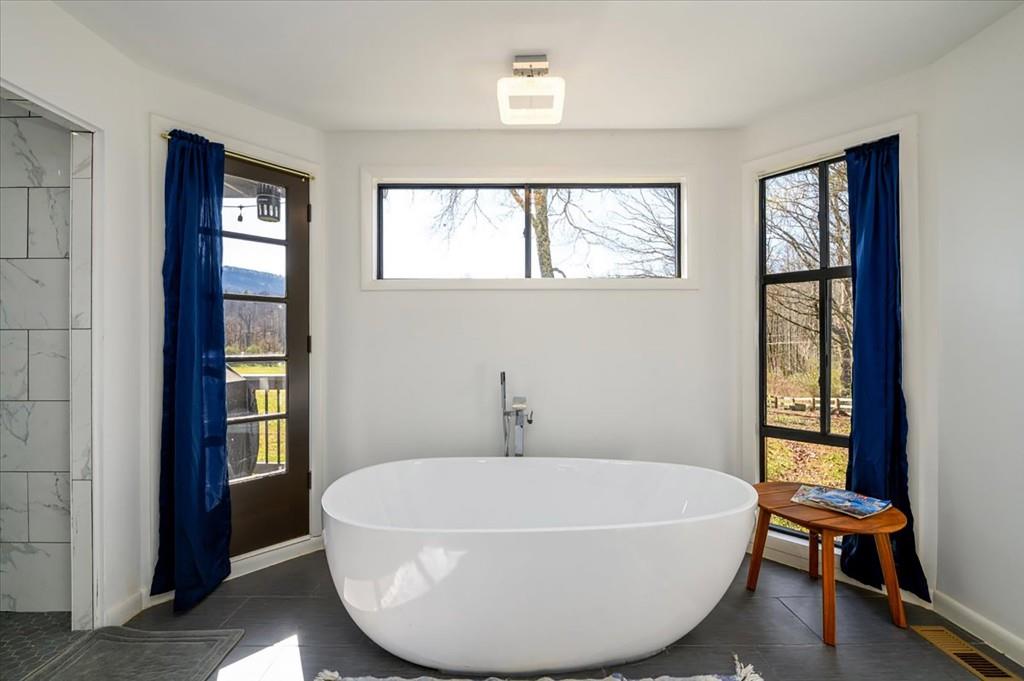 3274 Highway 255 Sautee Nacoochee, GA 30571 - Photo 29 of 77 a white bath tub sitting next to a window