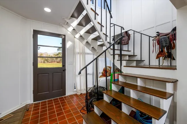 a bedroom with a bed and a large mirror