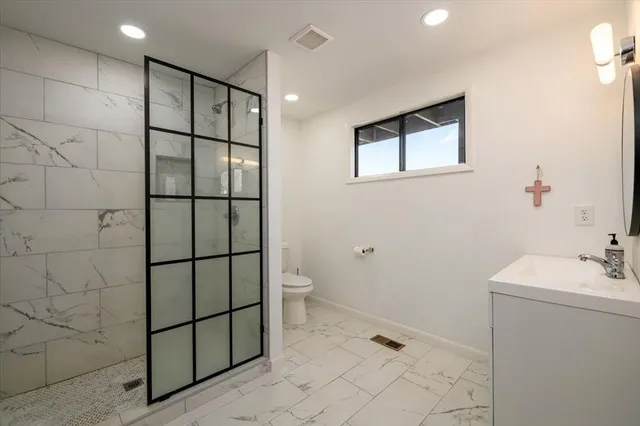 a balcony with wooden floor and outdoor seating