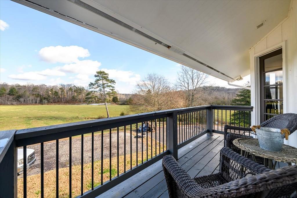 3274 Highway 255 Sautee Nacoochee, GA 30571 - Photo 58 of 77 a balcony with wooden floor and outdoor seating