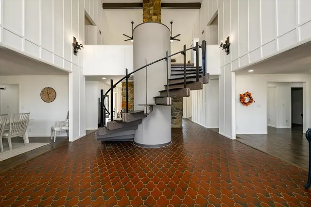 a living room with furniture a flat screen tv and gym equipment