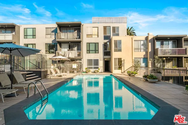 a view of a swimming pool with outdoor seating
