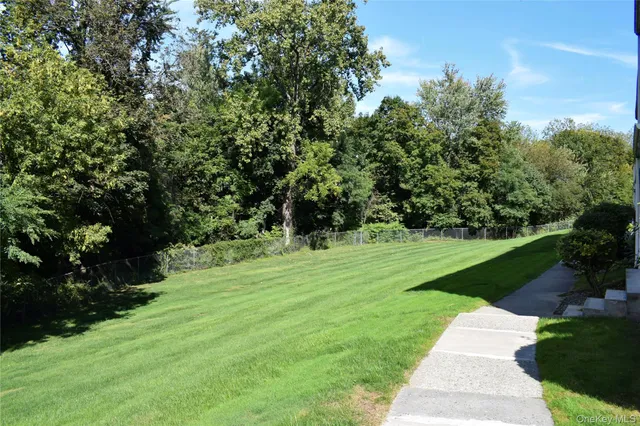 a view of a balcony with wooden floor & fence