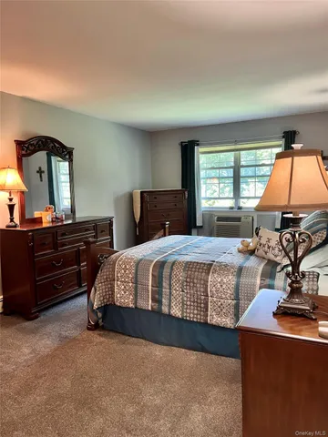 a bathroom with a granite countertop sink a toilet a mirror and shower