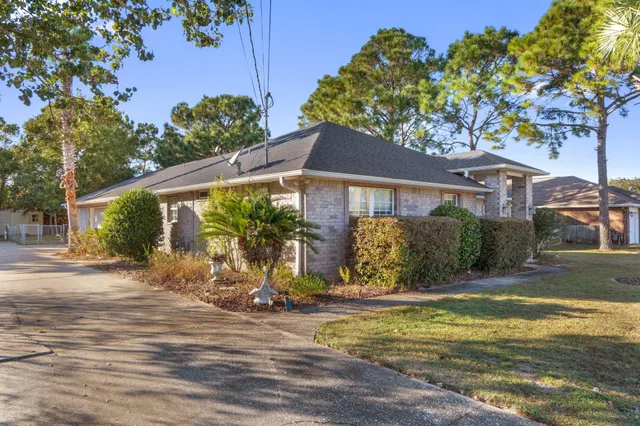 a view of a house with backyard and sitting area