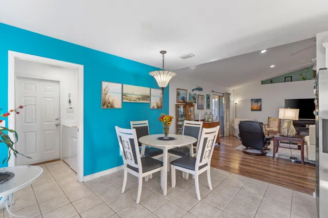 a dining room with furniture a chandelier and window