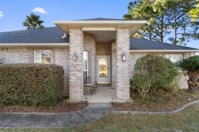 a view of a brick house with large windows