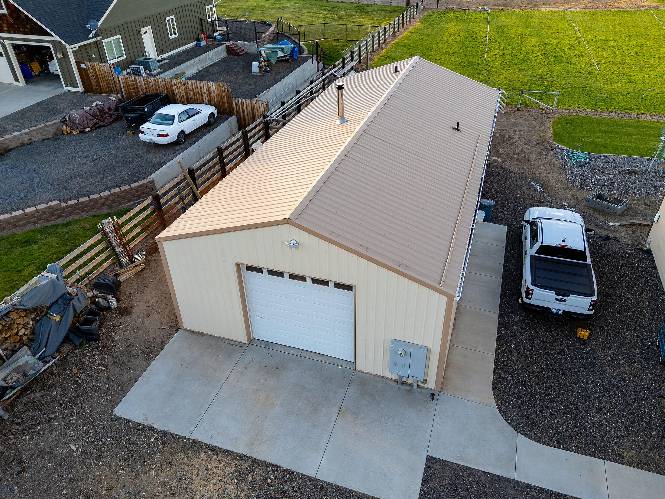 411 Northwest Mc Donald Road Prineville, OR 97754 - Photo 37 of 47 Aerial view of shop, concrete walkway from garage and to the apartment ADU.