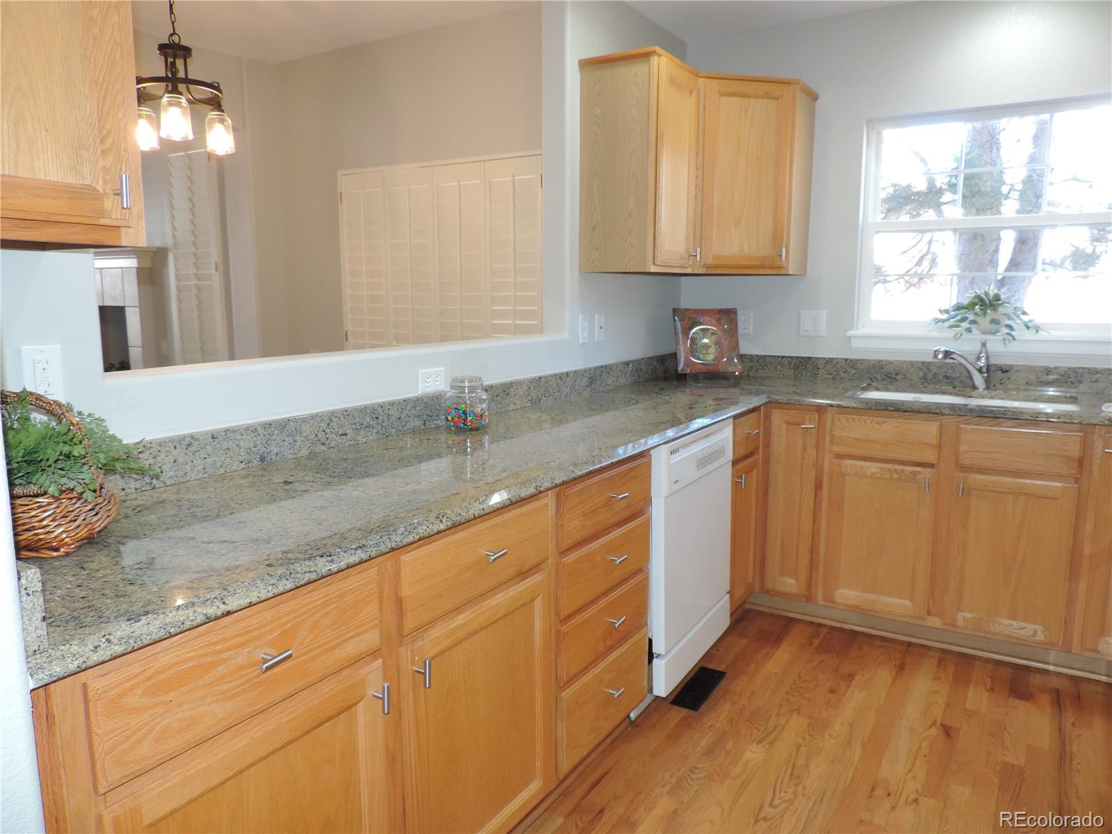 6239 Trailhead Road Highlands Ranch, CO 80130 - Photo 15 of 47 a kitchen with sink cabinets and window