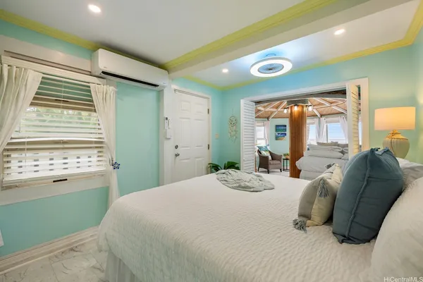 a bedroom with a bed and a large window
