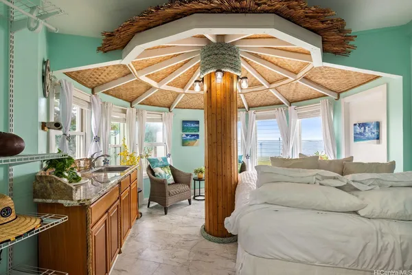 a living room with furniture and a umbrella
