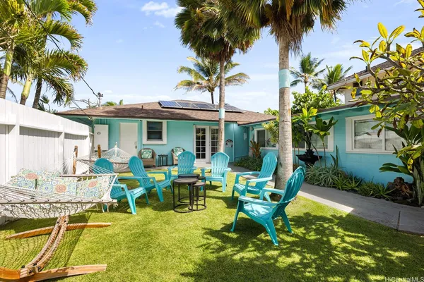 a view of a house with backyard porch and swimming pool