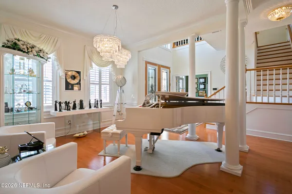 a living room with furniture a fireplace and a large window