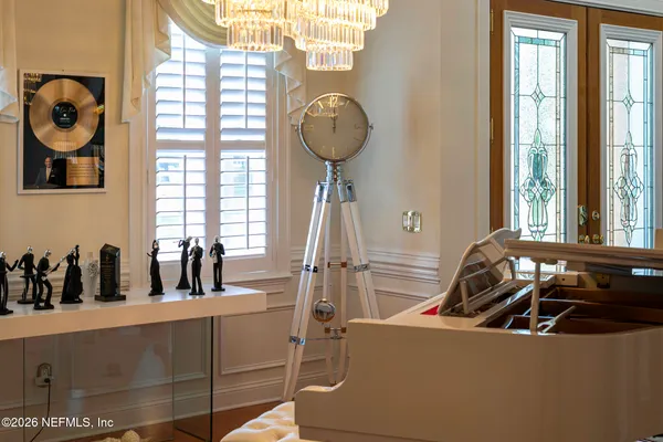 a living room with furniture and a chandelier