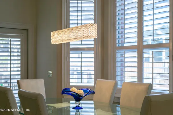 a bathroom with a sink a toilet a mirror and shower