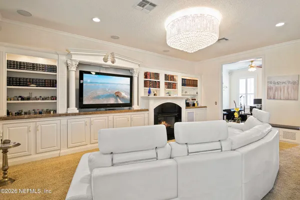 a view of a patio with couches table and chairs and potted plants