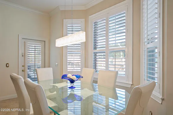 a living room filled with furniture and a floor to ceiling window