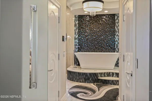 a living room with stainless steel appliances granite countertop furniture and a kitchen view