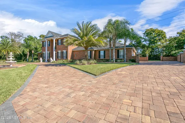 a view of a hallway with wooden floor and entryway