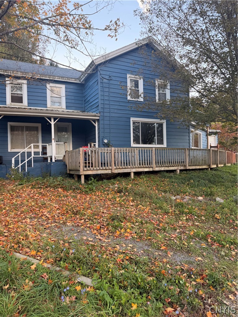 2025 Apulia Road LaFayette, NY 13084 - Photo 1 of 16 An elevated wooden deck stretches across the back of this blue multi-level home.