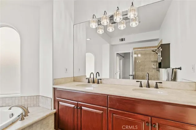 a bathroom with a double vanity sink and a mirror