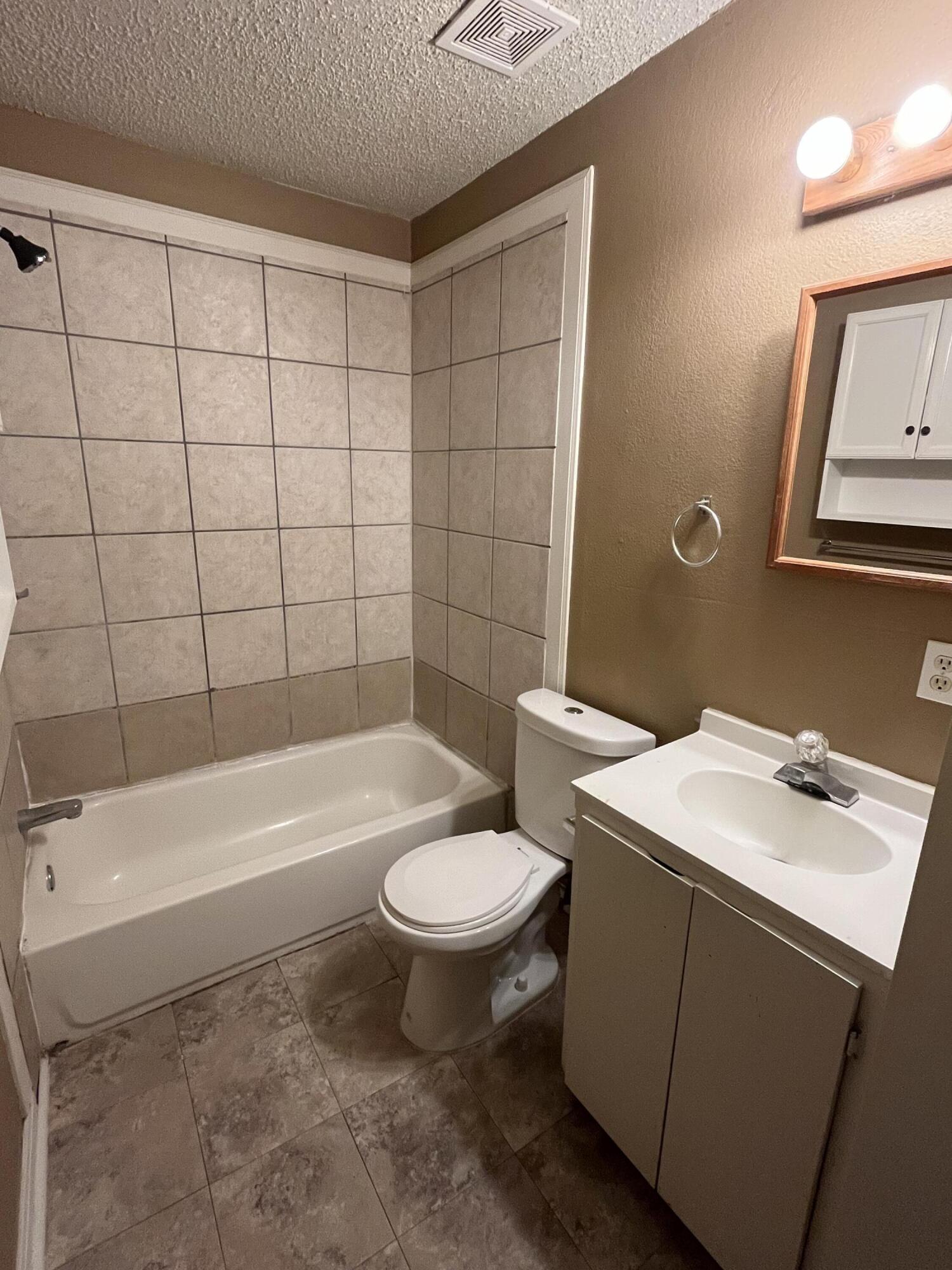 2111 25th Street Lubbock, TX 79411 - Photo 5 of 8 a bathroom with a sink toilet and shower