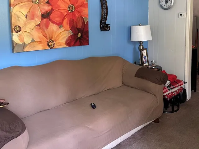 a bedroom with a bed and a lamp with the wall