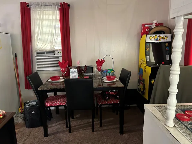 a view of a dining room with furniture and window