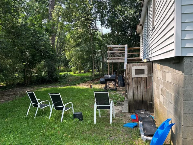 a view of backyard with outdoor seating ad green space