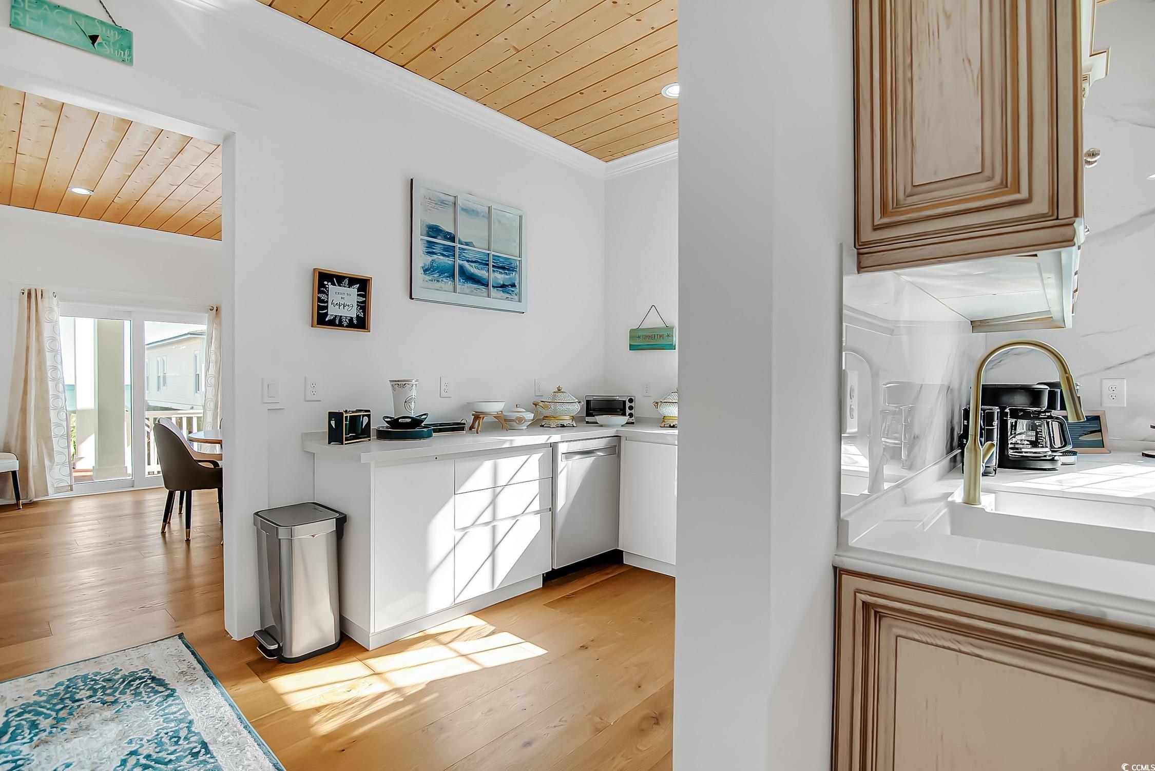 139 Pioneer Loop Georgetown, SC 29440 - Photo 14 of 39 Bar area with wood ceiling, light wood-style flooring, dishwasher, light stone counters, and crown molding