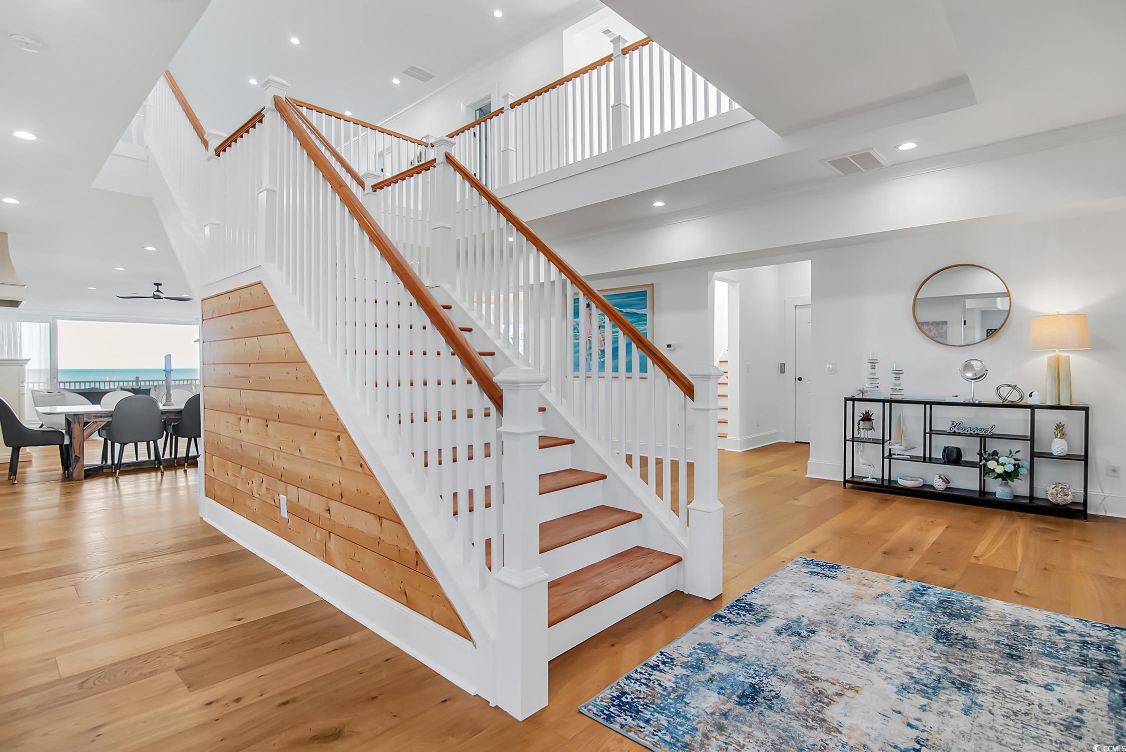 139 Pioneer Loop Georgetown, SC 29440 - Photo 17 of 39 Stairs featuring a high ceiling, recessed lighting, and wood finished floors