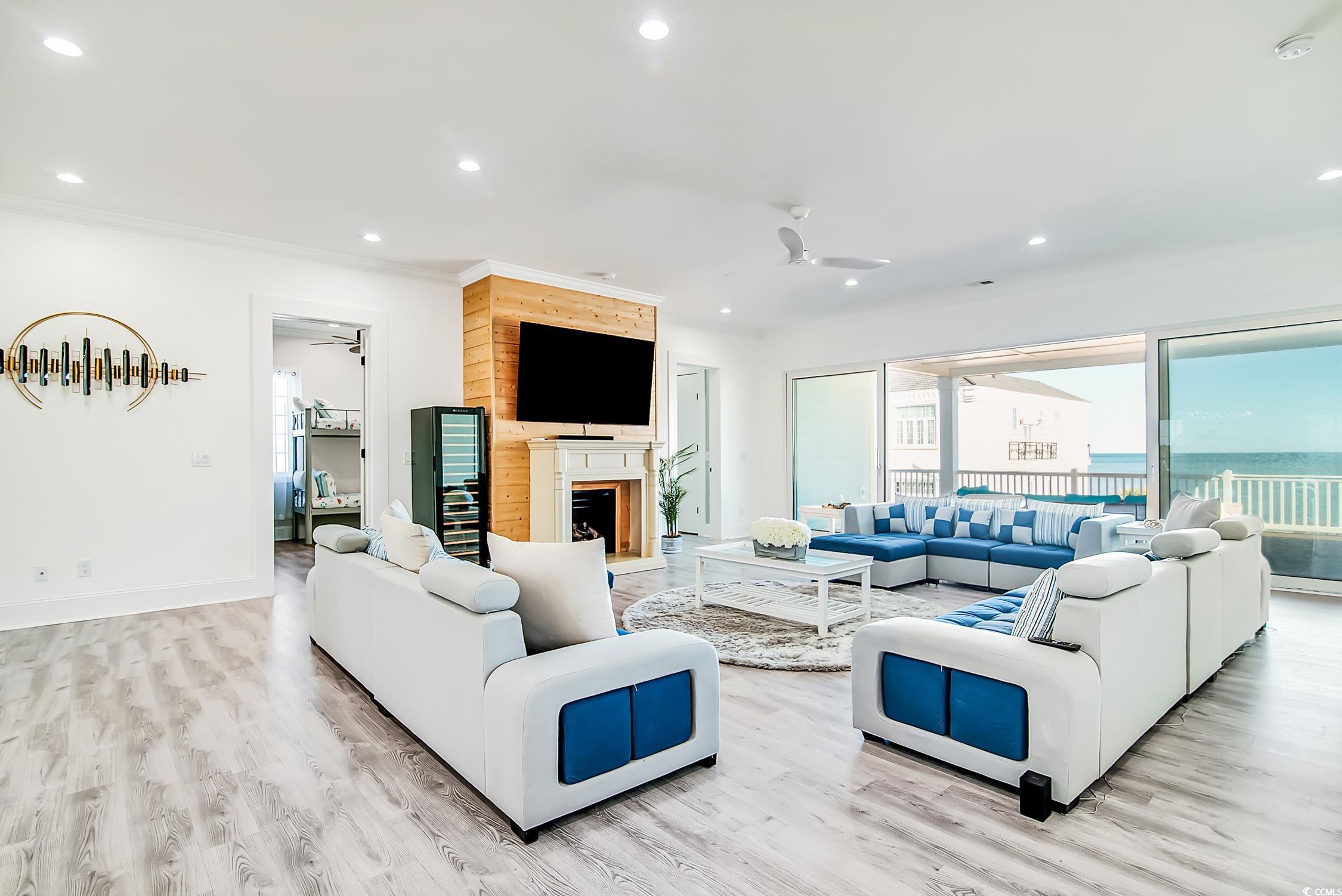 139 Pioneer Loop Georgetown, SC 29440 - Photo 20 of 39 Living room with recessed lighting, a ceiling fan, light wood-style flooring, and a fireplace with raised hearth