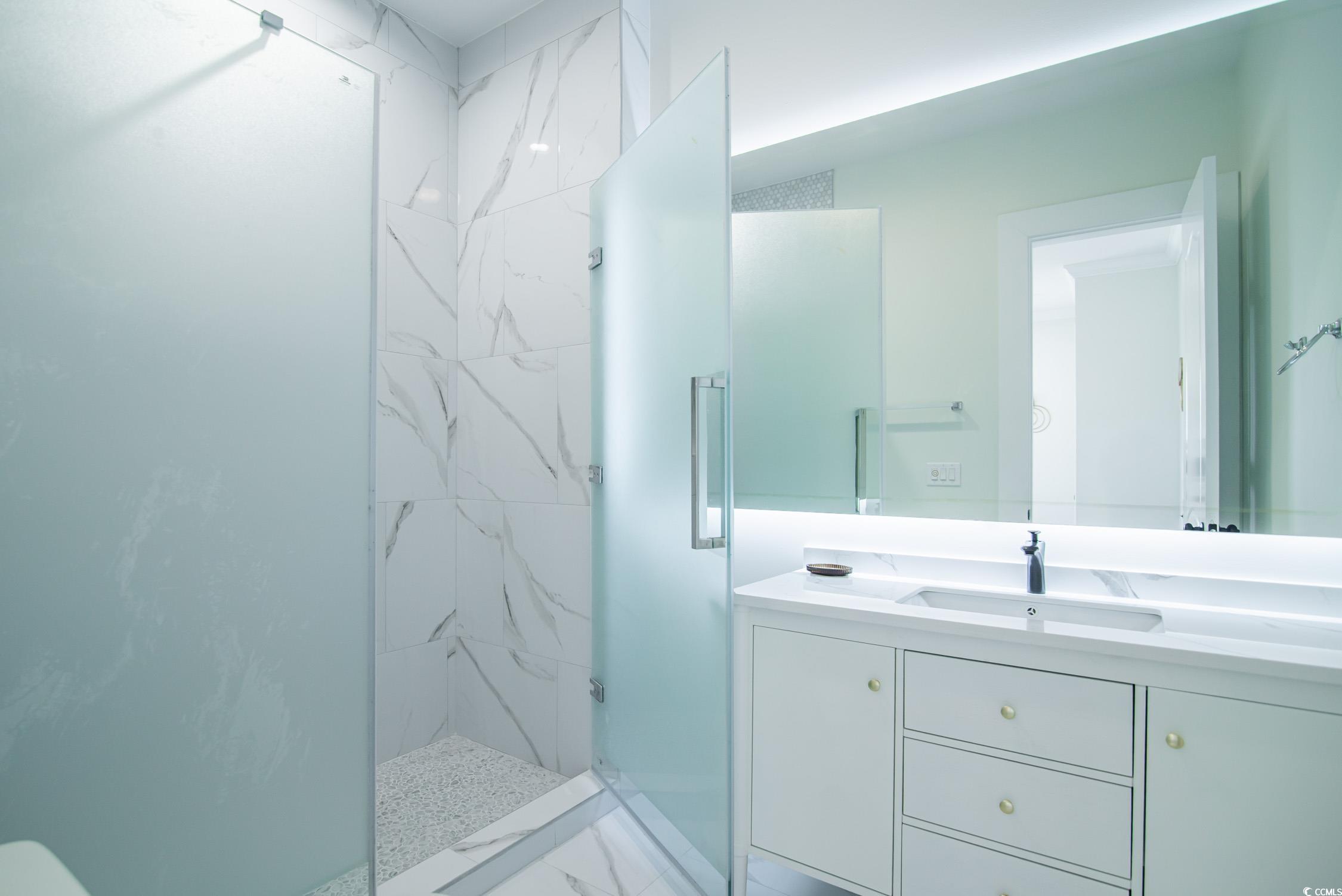139 Pioneer Loop Georgetown, SC 29440 - Photo 24 of 39 Bathroom featuring vanity, a marble finish shower, and light marble finish floors