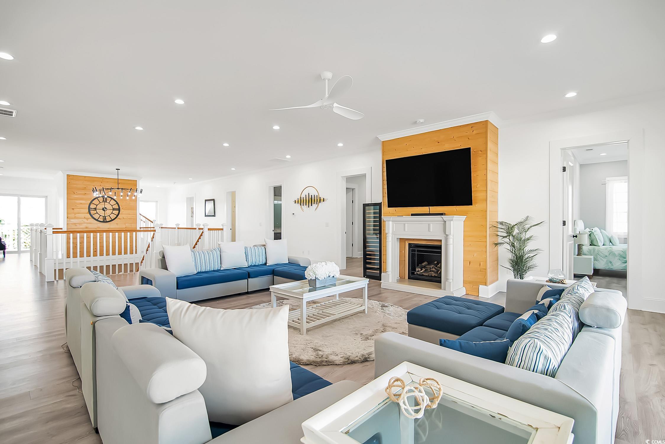 139 Pioneer Loop Georgetown, SC 29440 - Photo 28 of 39 Living room with healthy amount of natural light, recessed lighting, light wood-style flooring, ceiling fan, and a fireplace with raised hearth