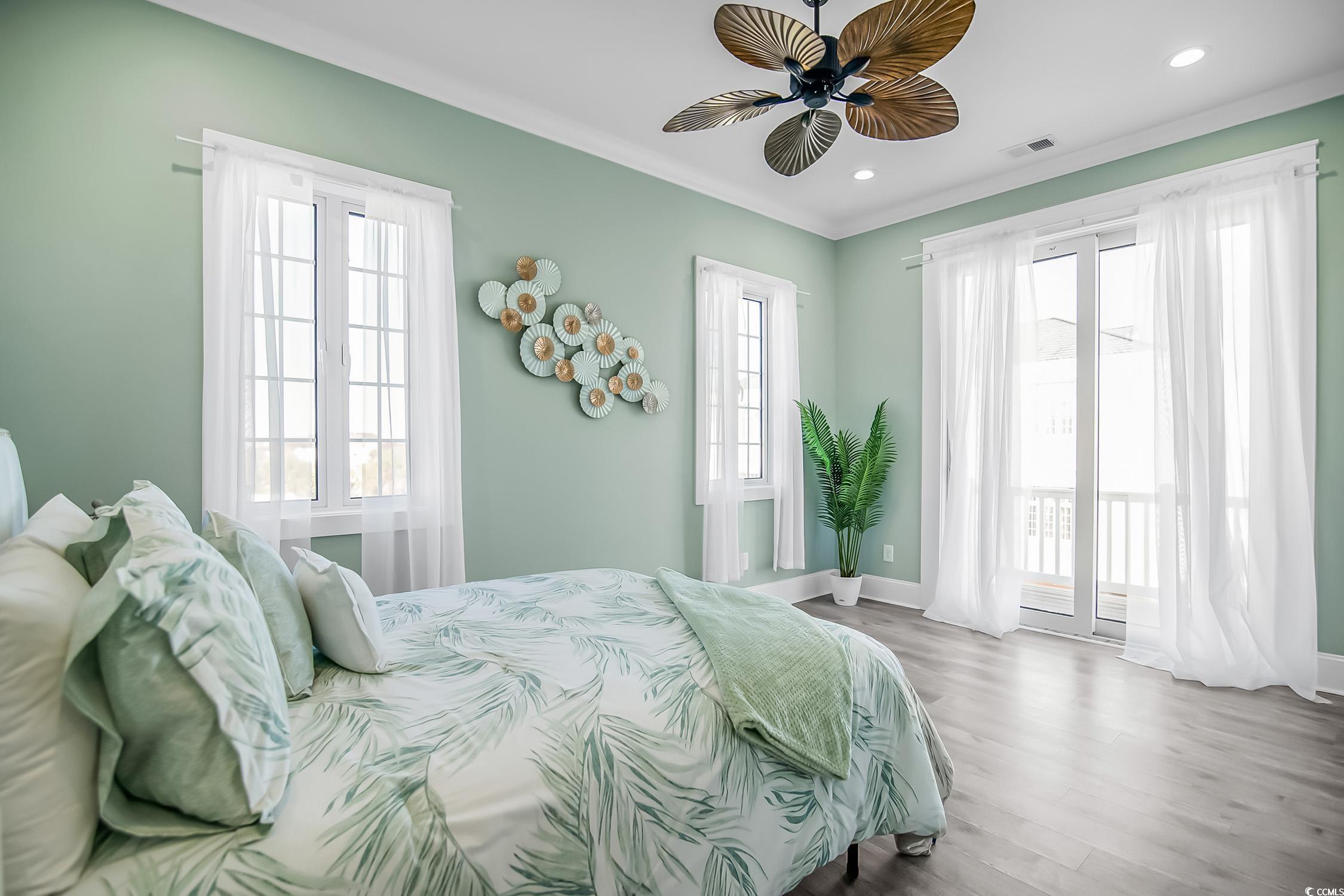 139 Pioneer Loop Georgetown, SC 29440 - Photo 29 of 39 Bedroom with wood finished floors, access to exterior, ornamental molding, ceiling fan, and recessed lighting