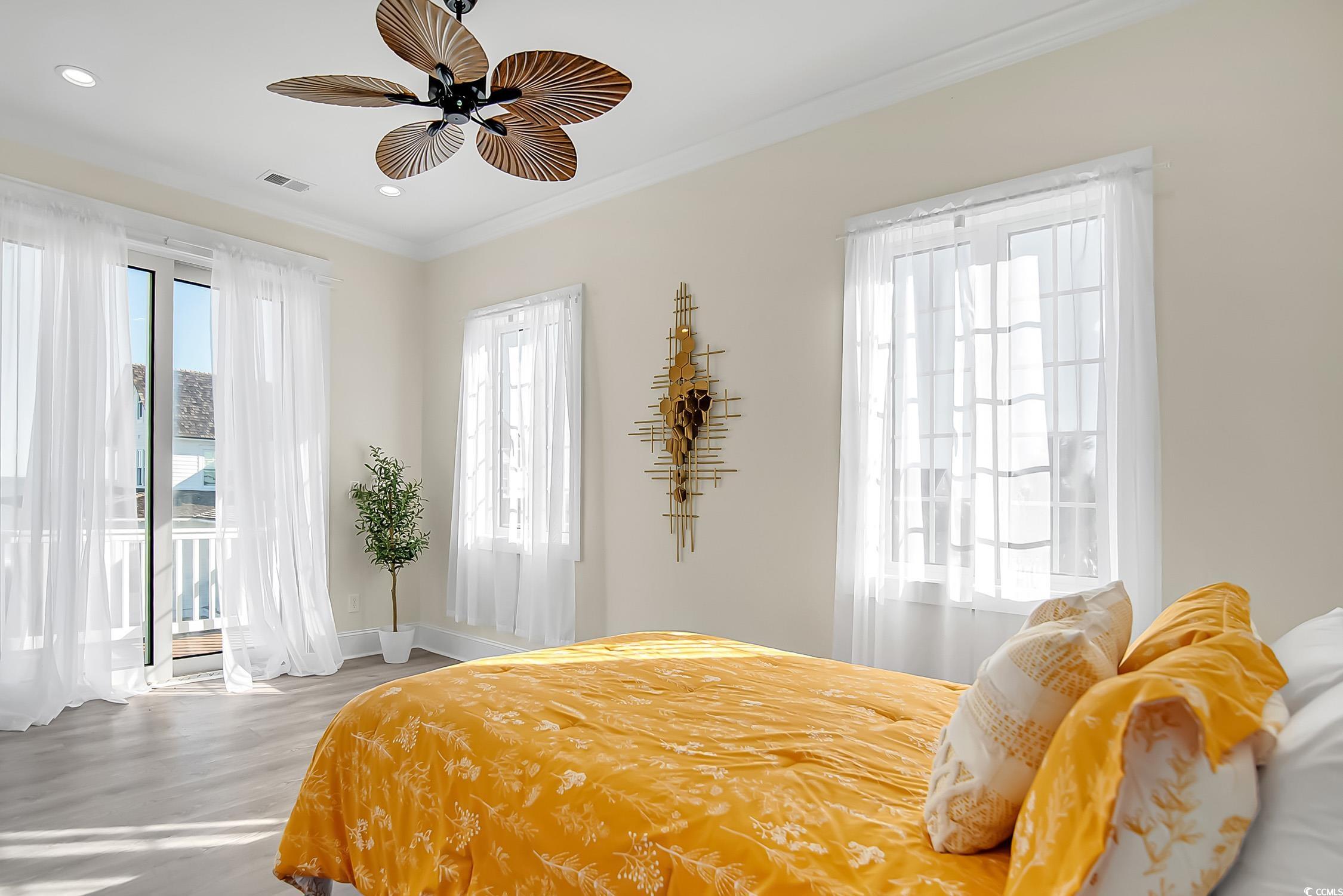 139 Pioneer Loop Georgetown, SC 29440 - Photo 31 of 39 Bedroom with access to exterior, crown molding, wood finished floors, multiple windows, and recessed lighting