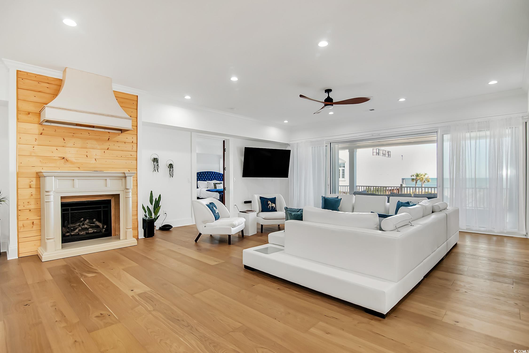 139 Pioneer Loop Georgetown, SC 29440 - Photo 9 of 39 Living area featuring recessed lighting, light wood-style floors, a ceiling fan, and a fireplace with raised hearth