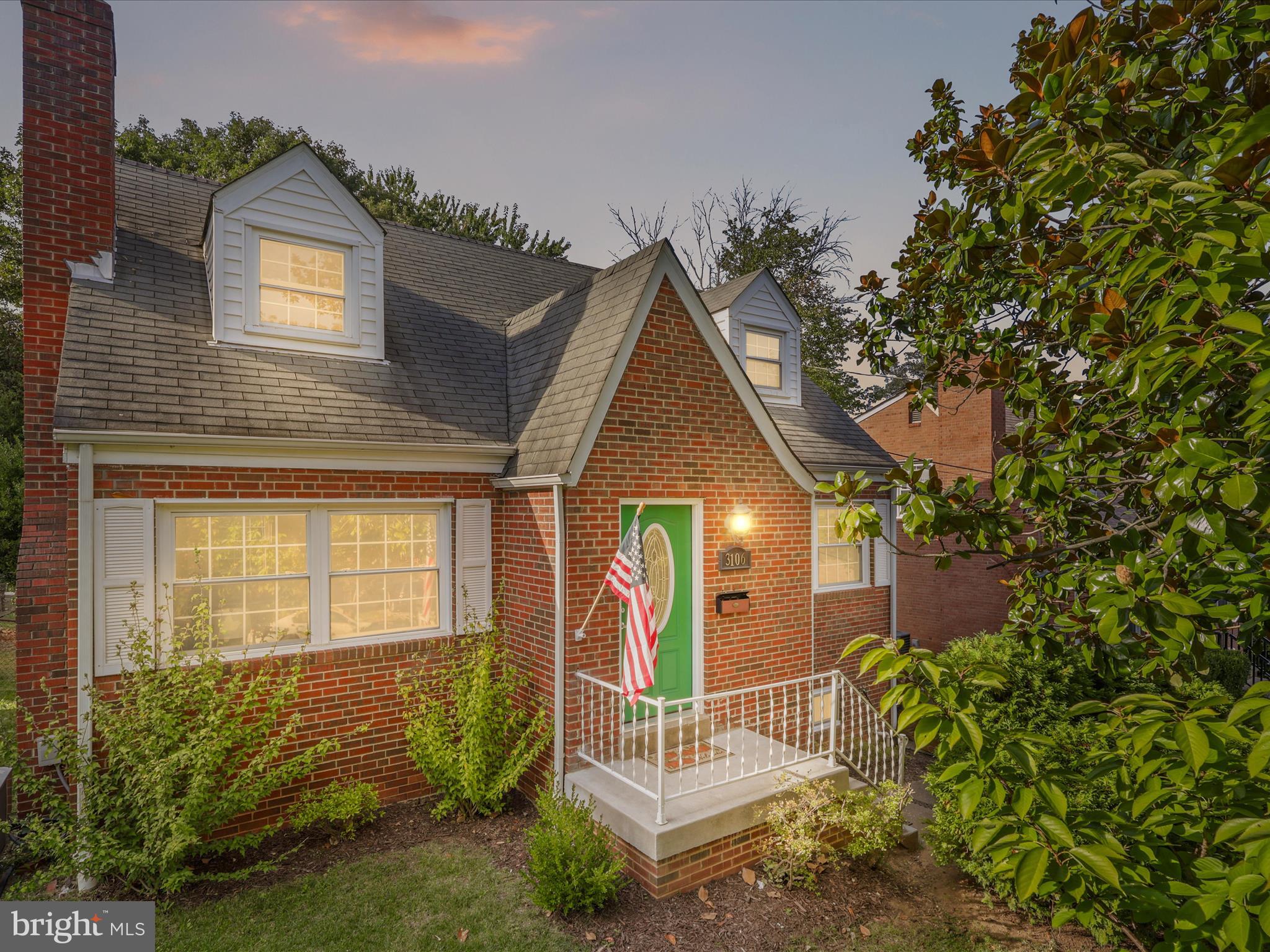 a view of house with a yard and potted plants