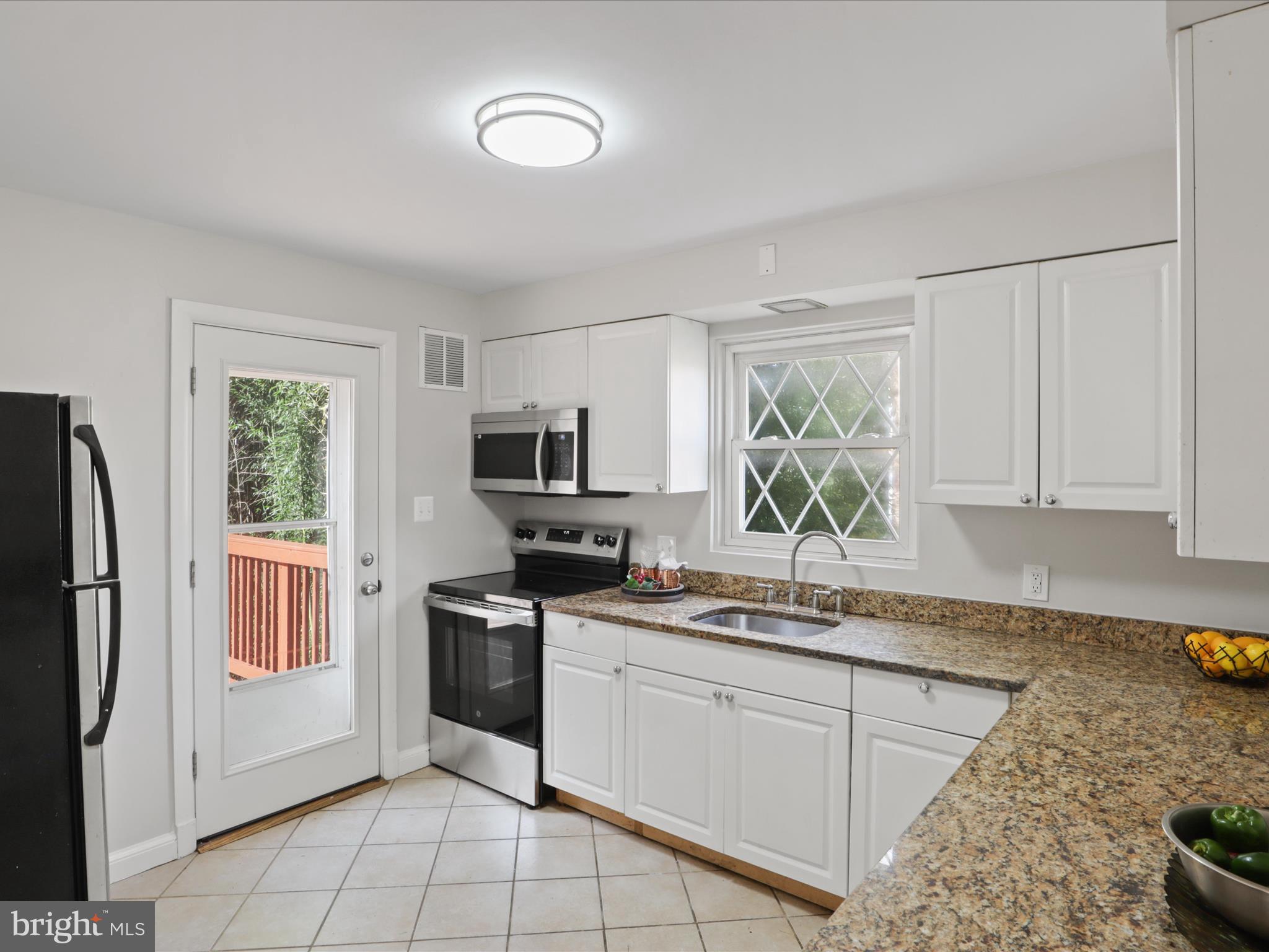 3106 63rd Place Cheverly, MD 20785 - Photo 11 of 42 a kitchen with stainless steel appliances granite countertop a refrigerator sink and stove